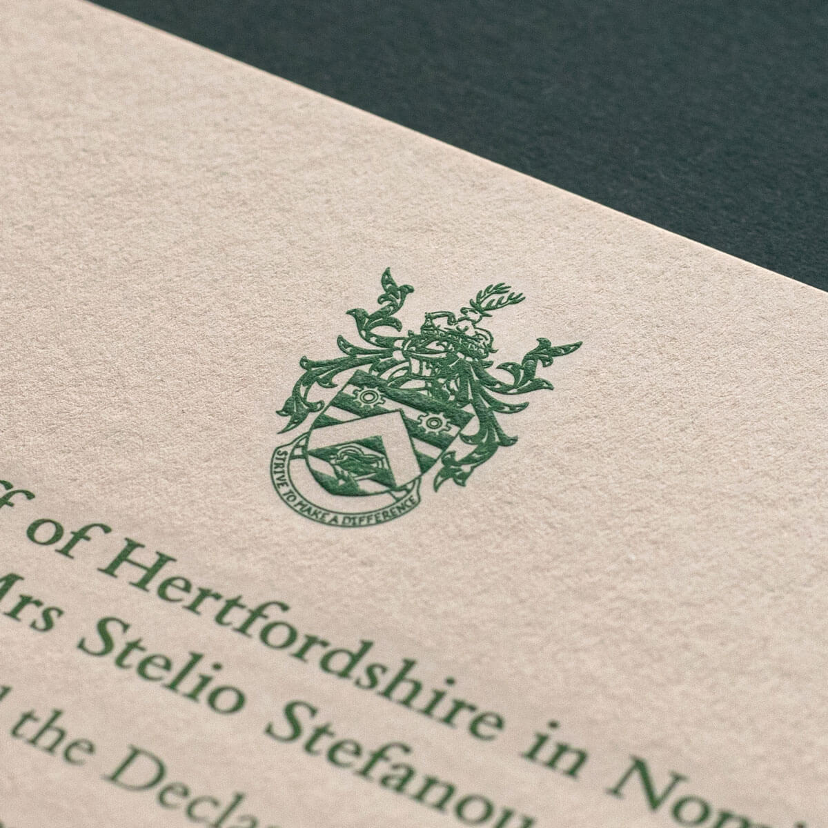 engraved detailed green logo on an invitation printed in london