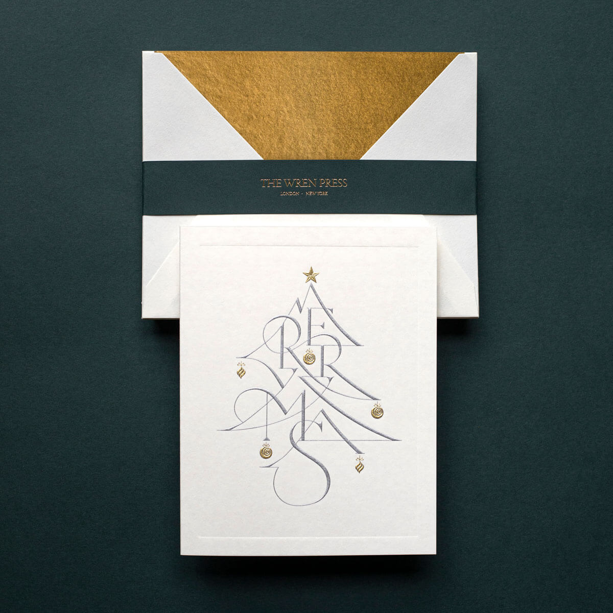 gold and silver engraved christmas tree on white card gold tissue lined envelope