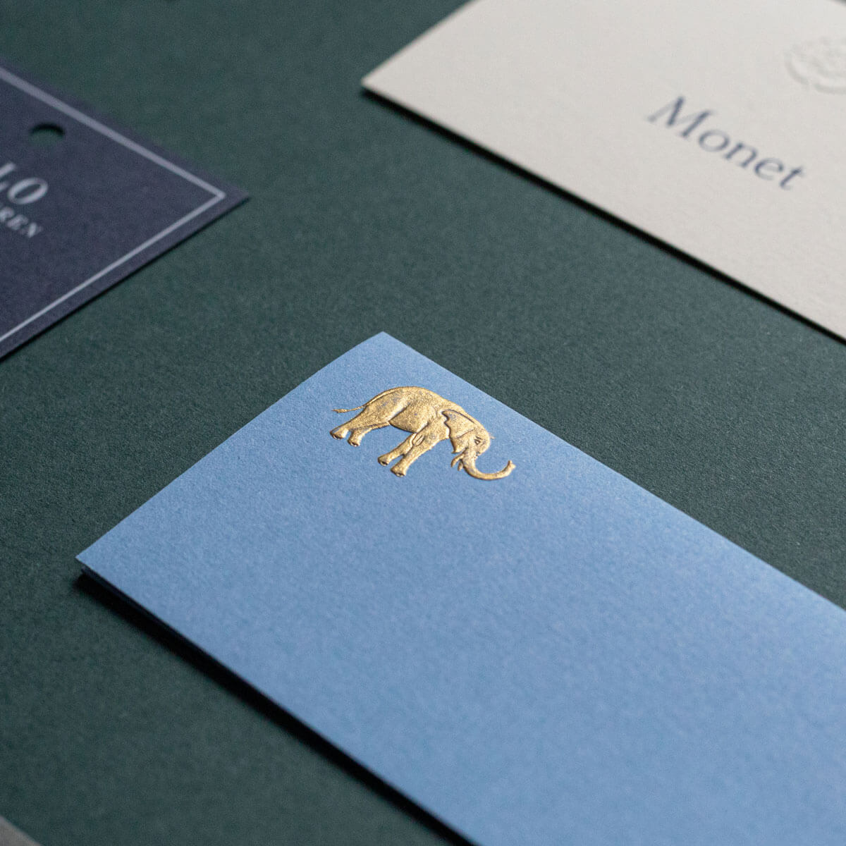 gold embossed die stamped elephant engraved onto blue business cards