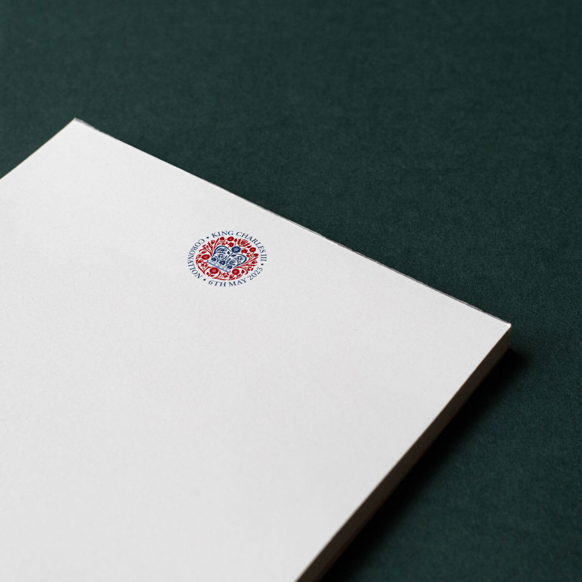 red and blue logo on white paper notepad printed with king charles coronation logo
