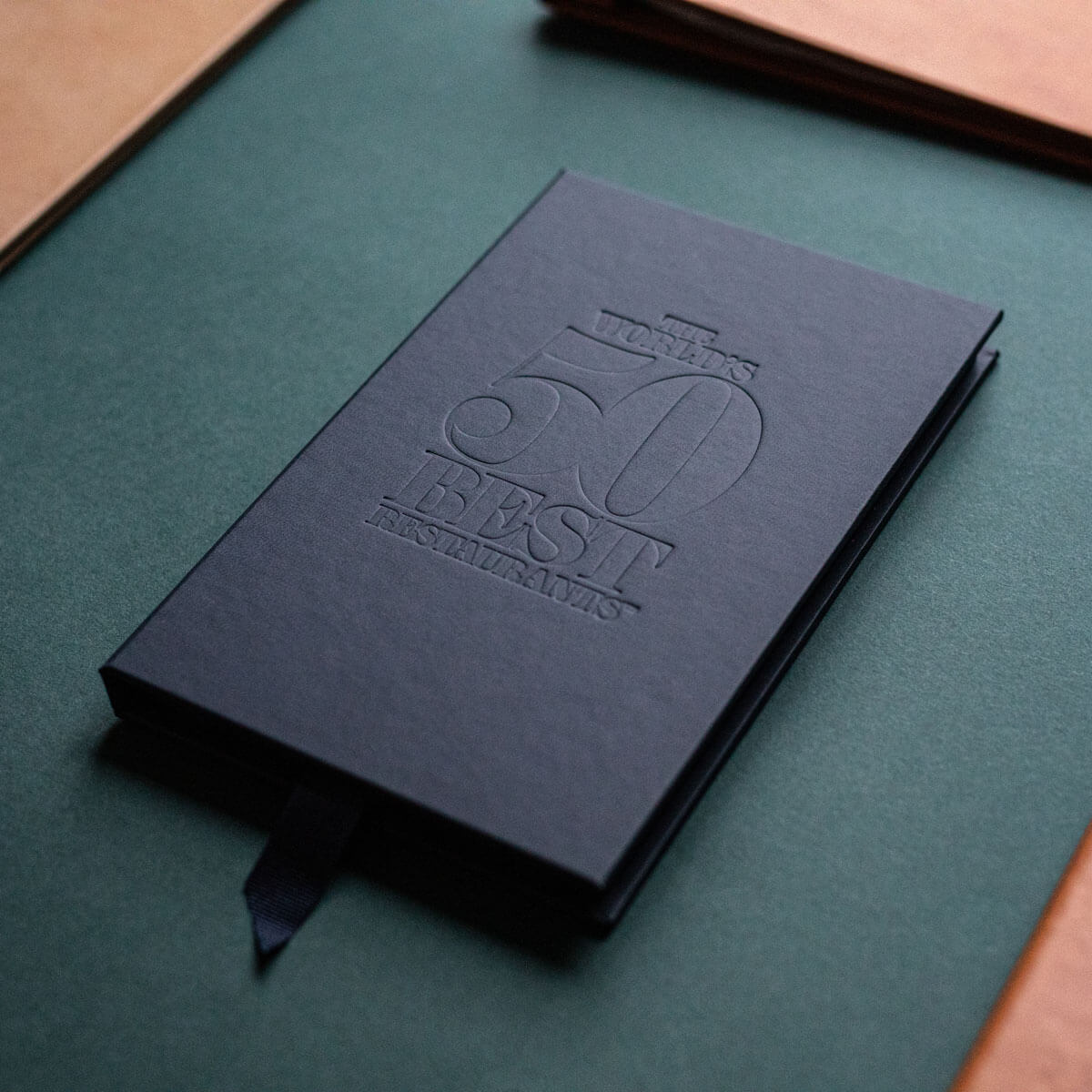 black leather folder with a debossed logo printed in london
