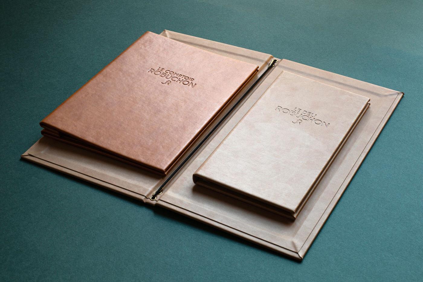 brown and tan leather menu folders with a debossed logo printed in mayfair london