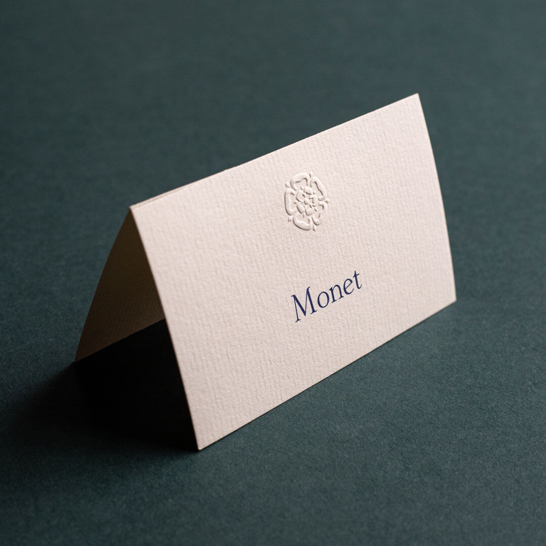 a premium quality off-white business card with an embossed motif