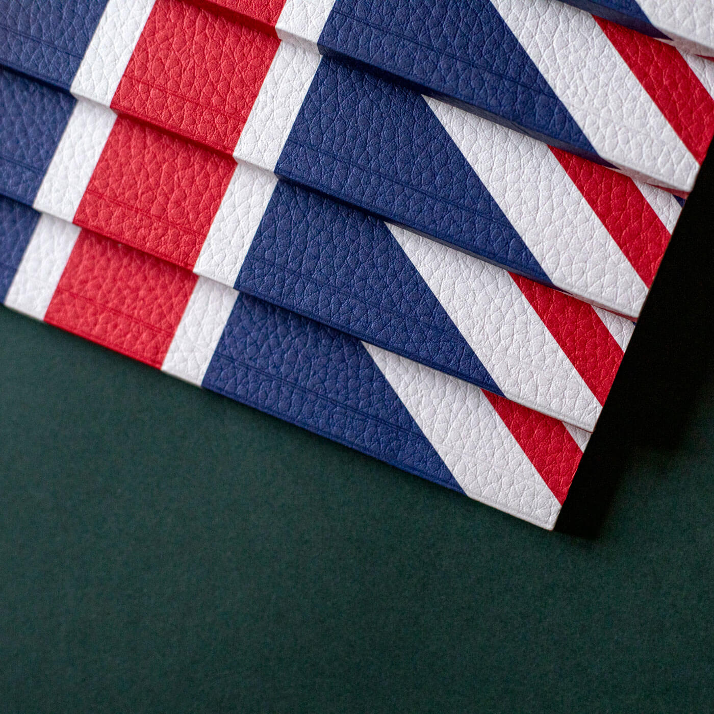 closeup of luxury leather look paper stacked union jack notebooks 