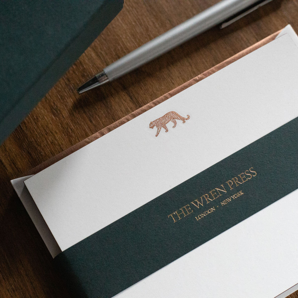 luxury notecards with engraved bronze leopard logo and gilded edges and tissue lined envelopes