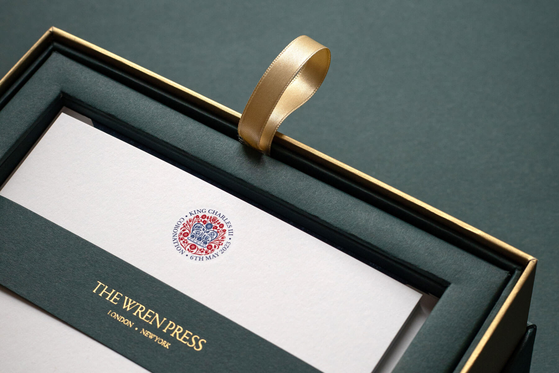 close up of kings coronation engraved logo red and blue in box set